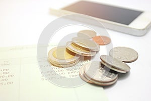 Coins and phone on account book bank for finance and banking. Business concept