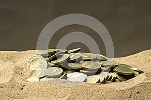 Coins in the sand