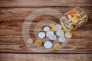 Coins spilling from glass jar