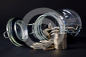 Coins spilling out jar