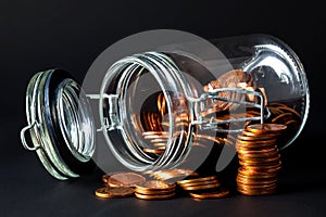 Coins spilling out jar