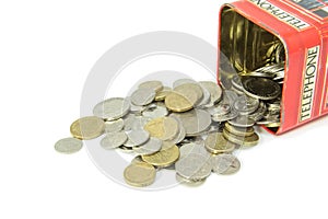 Coins spilling out of money box