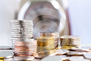 Coins stack on clock background.