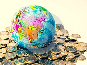 Coins stack and globe Invest your money to get in come, growing business and future concept