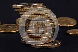 Coins stacked close-up on black background