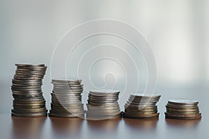 Coins stacked on each other in a row, business and finance concept