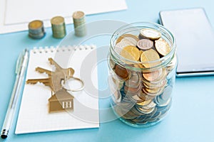 The coins are stored in a glass jar to accumulate finances.