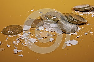 Coins of ten Mexican pesos, which have been removed from a piggy bank that broke