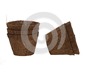 Coir plant pots isolated on white. Environmentally friendly spring gardening. Peat substitute.