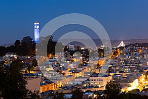 Coit tower and houses in San Francisco at night