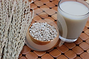 Coix lacryma-jobi, boiled in a glass on a brown background