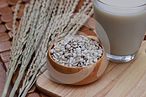 Coix lacryma-jobi, boiled in a glass on a brown background