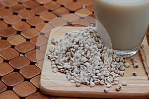 Coix lacryma-jobi, boiled in a glass on a brown background