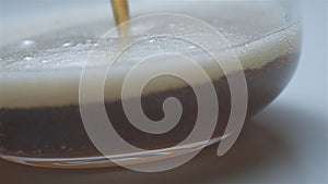 Coke pouring in glass macro slowmotion