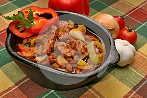 Coked pork meat with peppers