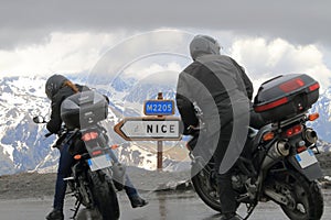 Motor bikers near signposting at Col de la Bonette, France