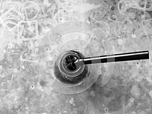 Cola bottle on table in black and white
