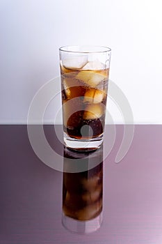 Cola - cola and ice cubes in glass on white background