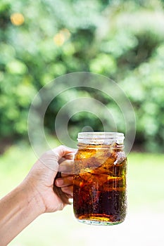 Cola cola sparkling water in a glass with ice