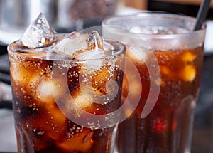 Cola with crushed ice in glass and there is water droplets around. cool black fresh drink