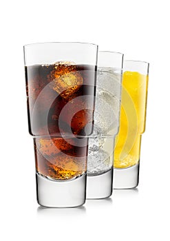 Cola with lemonade and orange soda soft drink with ice cubes in luxury glasses