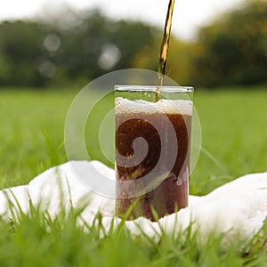 Cola pouring in a glass