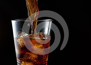 Cola pouring into iced glass