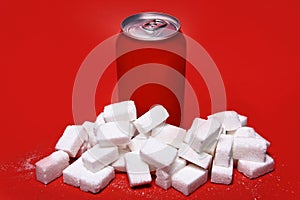 Cola refreshing drink can and lot of white sugar cubes represent