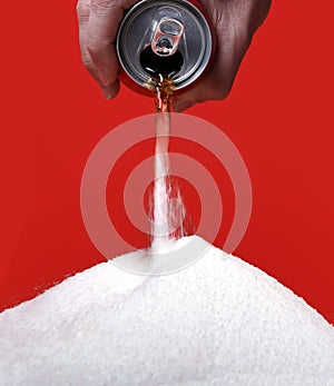 Cola refreshing drink can pouring the liquid as its transforming into pure white sugar