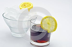 Cola with slice of lemon bowl of ice
