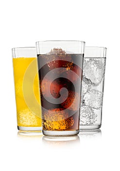 Cola soda drink with lemonade and orange soda with ice cubes and bubbles on white