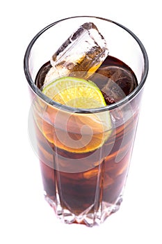 Cola in tall glass with ice cubes and lime