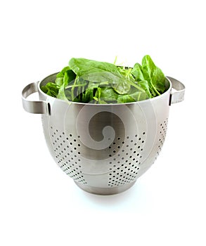 Colander with fresh spinach