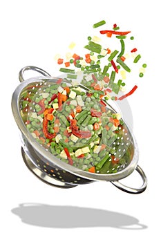 Colander with frozen mixed vegetables