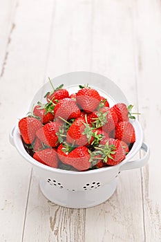 A colander full of Beautiful freshly picked strawberries
