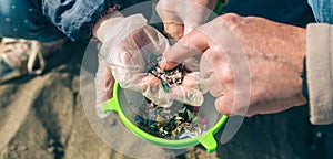 Colander with microplastics on the beach