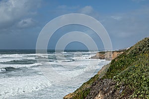 Beautiful beach on the Atlantic coast near Colares, Portugal, located at the foot of the Sierra de Sintra mountains photo