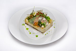 Cold appetizer of fish, vegetables on toast.