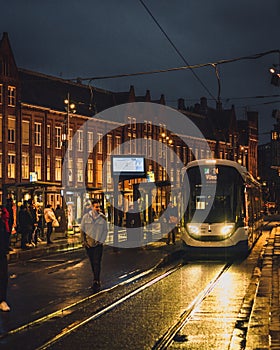 A cold autumn evening in Amsterdam, a tram stops outside Centraal Station.