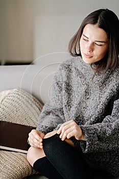 Woman legs in warm golfs and knitted sweater photo