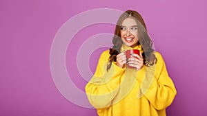 Cold autumn. Woman warming hands with cup