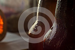 Cold beer bottle in droplets of water of their refrigerator
