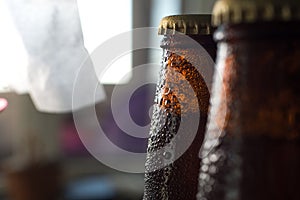 Cold beer bottle in droplets of water of their refrigerator