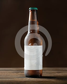 Cold beer bottle with drops