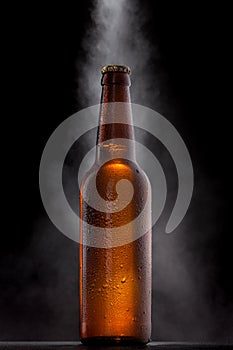 Cold beer bottle with drops