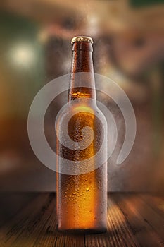 Cold beer bottle with drops, frost and vapour