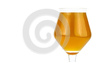 Cold beer in a Teku tasting glass filled to full with foam, drops of water on glass, the glass is on the right, isolated on a whit