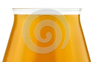 Cold beer in a Teku tasting glass filled to full with foam, drops of water on glass, the upper part of the glass is visible, isola