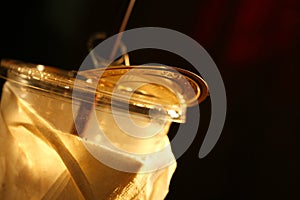 Cold beverage plastic cup scene.