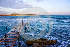 Cold blue winters Mediterranean sea & Fishing jetty waiting for the summer